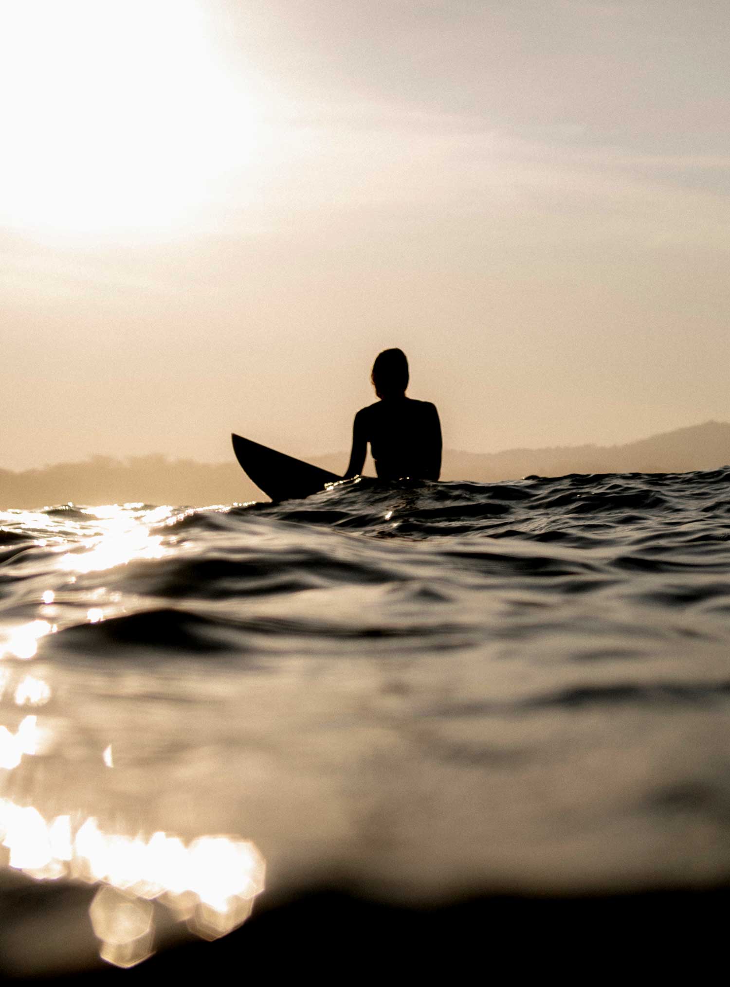 Surfer in sillouette on his own in the ocean