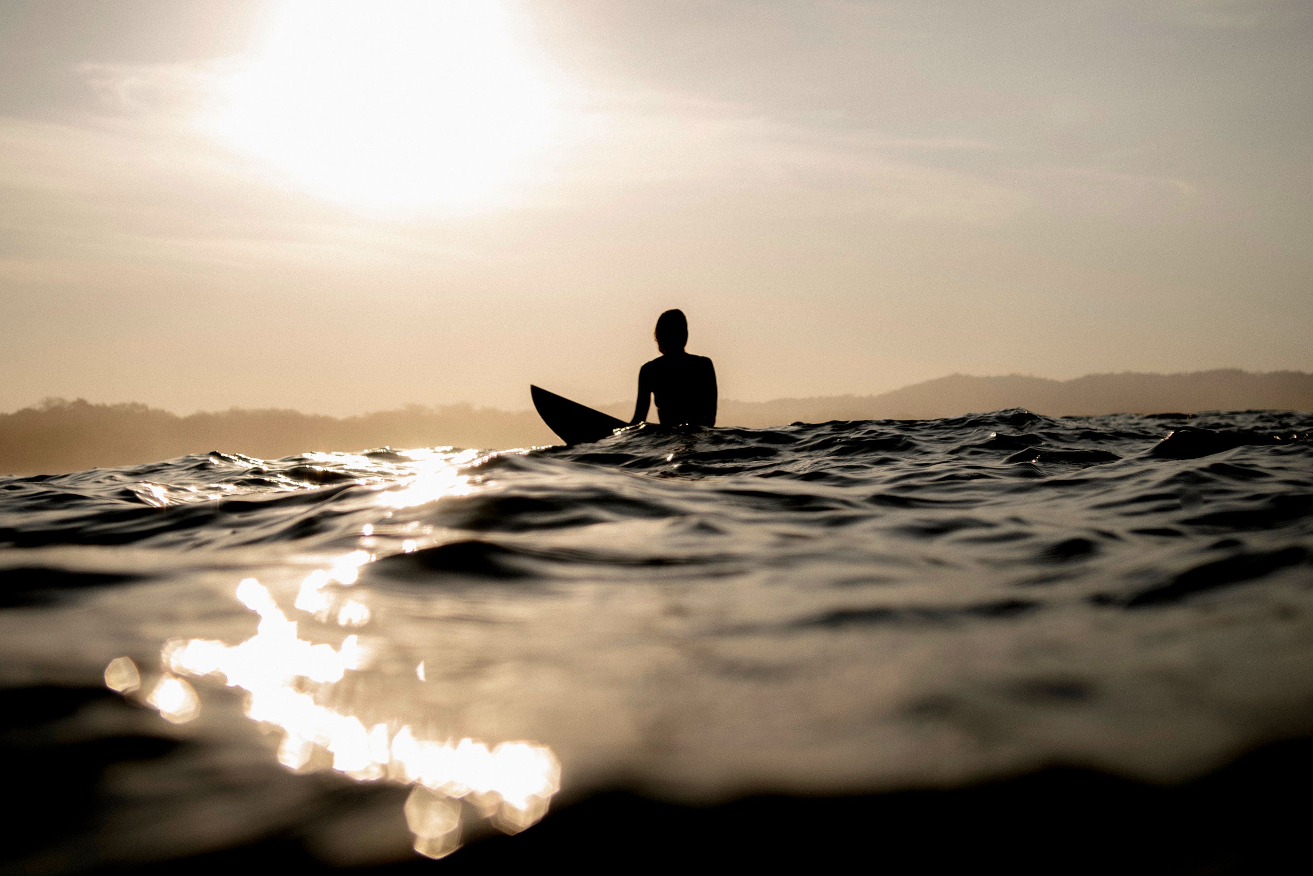 Surfer in sillouette on his own in the ocean