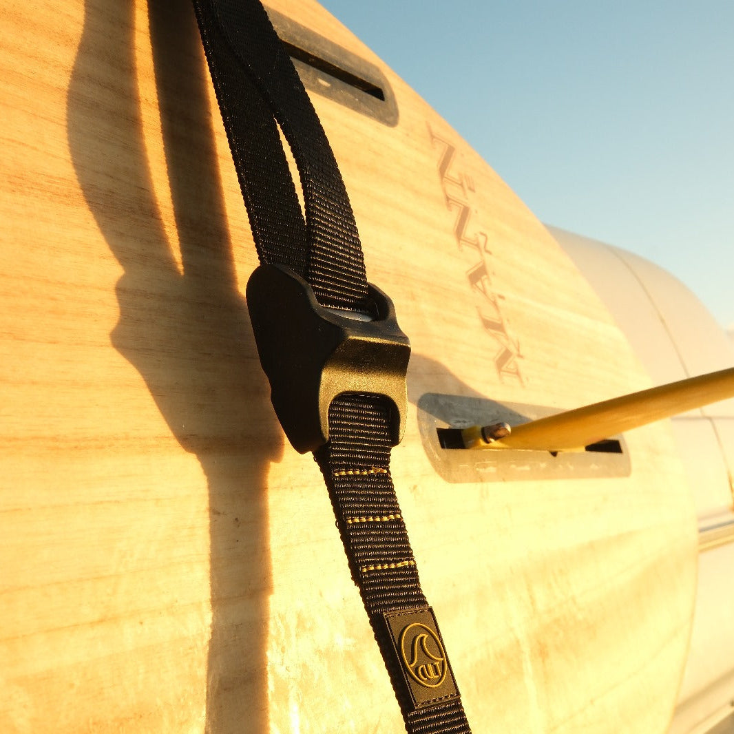 Cult straps on a surfboard