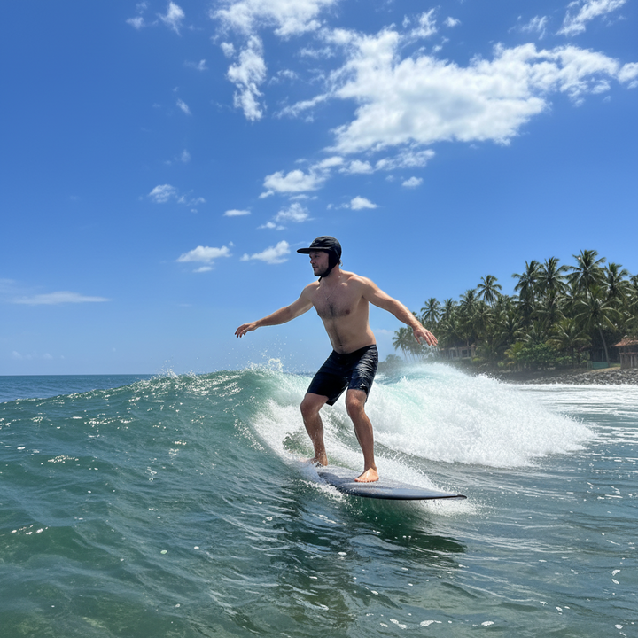 Man wearing a black helmet with a visor on a beach