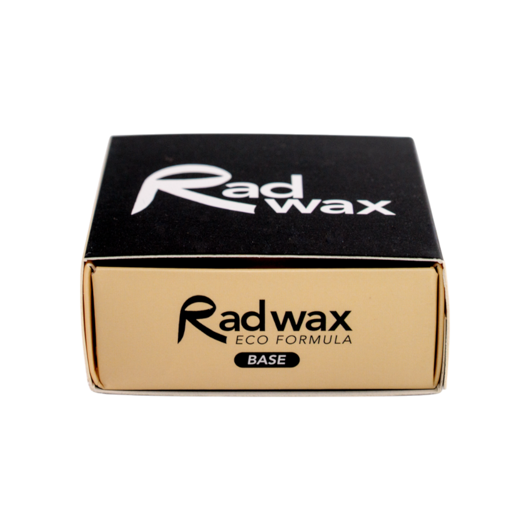 A square black and gold box of Radwax Eco Formula Base, featuring the brand name &
