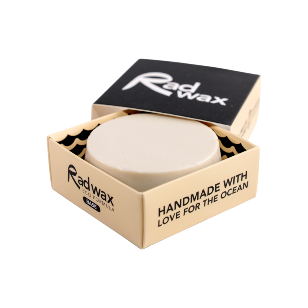 A round bar of Radwax wax in a beige cardboard container with a black lid, shown on a plain white background.