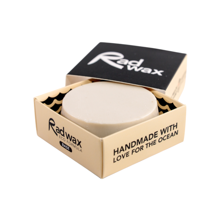 A round bar of Radwax wax in a beige cardboard container with a black lid, shown on a plain white background.