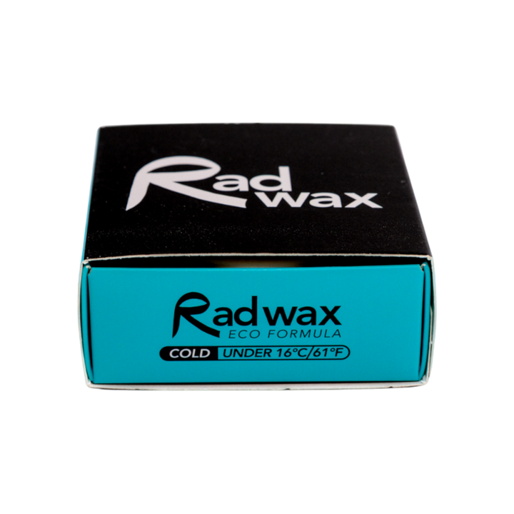 A square product box for Radwax Eco Formula Cold Wax, featuring a black top half with a white logo and a bright turquoise-blue bottom half with black text, set against a plain white background.