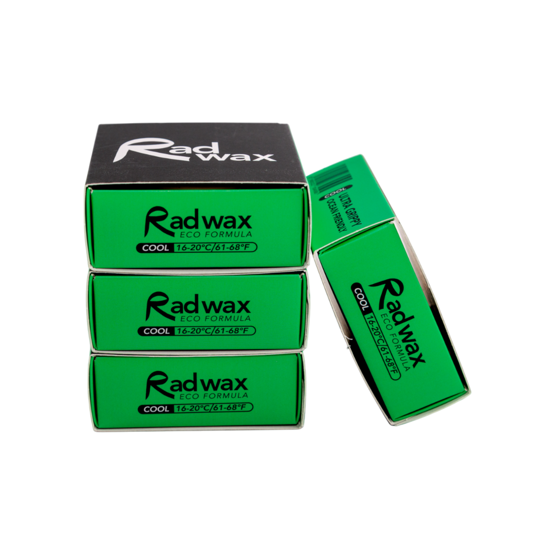 Four Radwax Eco Formula cooling wax packs arranged on a white background, with three stacked vertically and one leaning on the right. The packs are bright green with black text, and the top pack has a black top section with the Radwax logo.