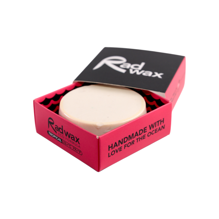 A round bar of Radwax soap in a pink and black cardboard presentation box, shown on a clean white background.