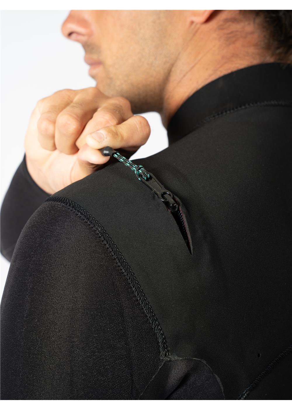 Close-up of Vissla wetsuit shoulder zip being adjusted.