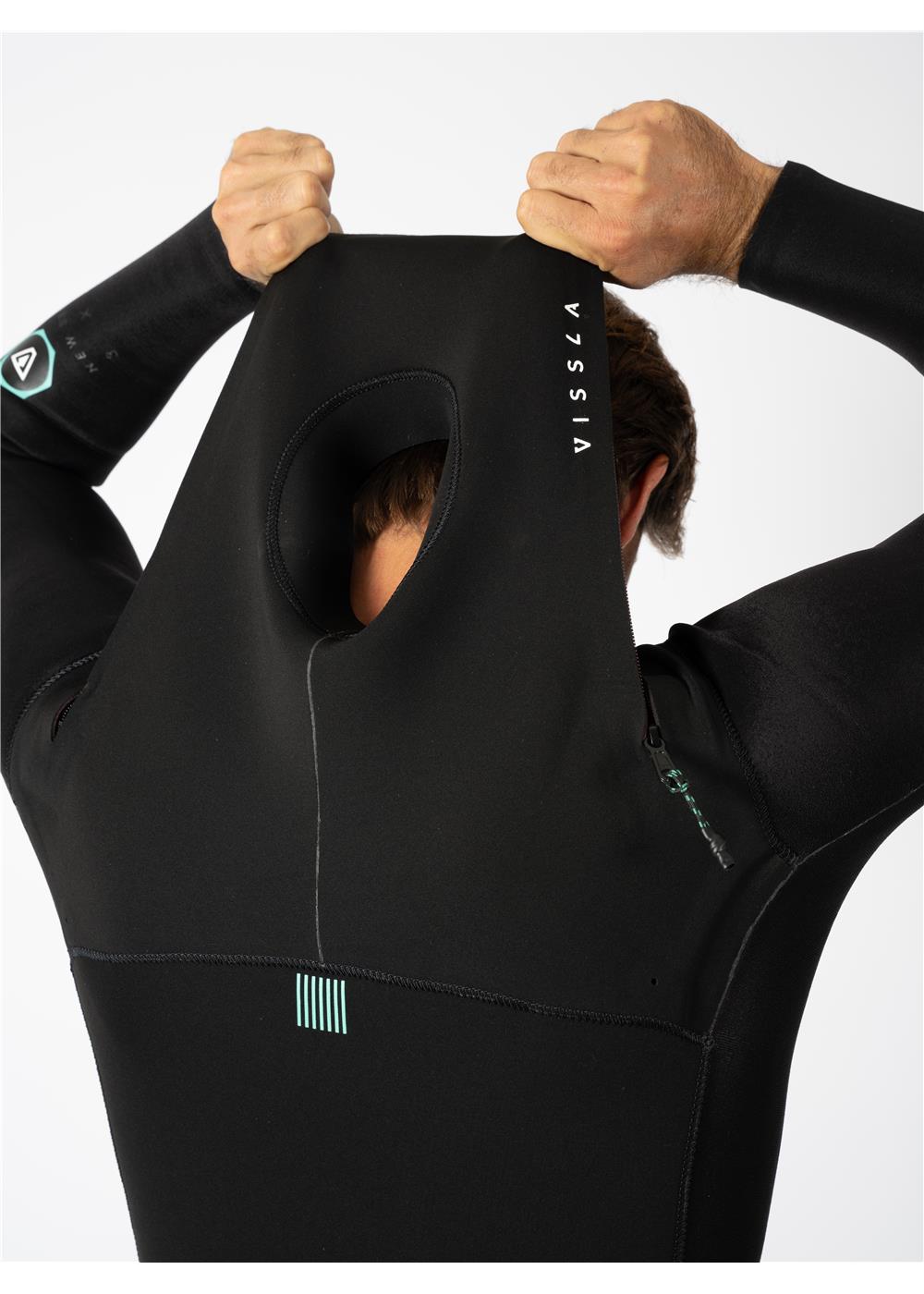 Man putting on Vissla wetsuit hood with logo detail.